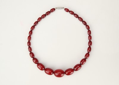 Lot 579 - A String of Graduated Cherry Amber Beads