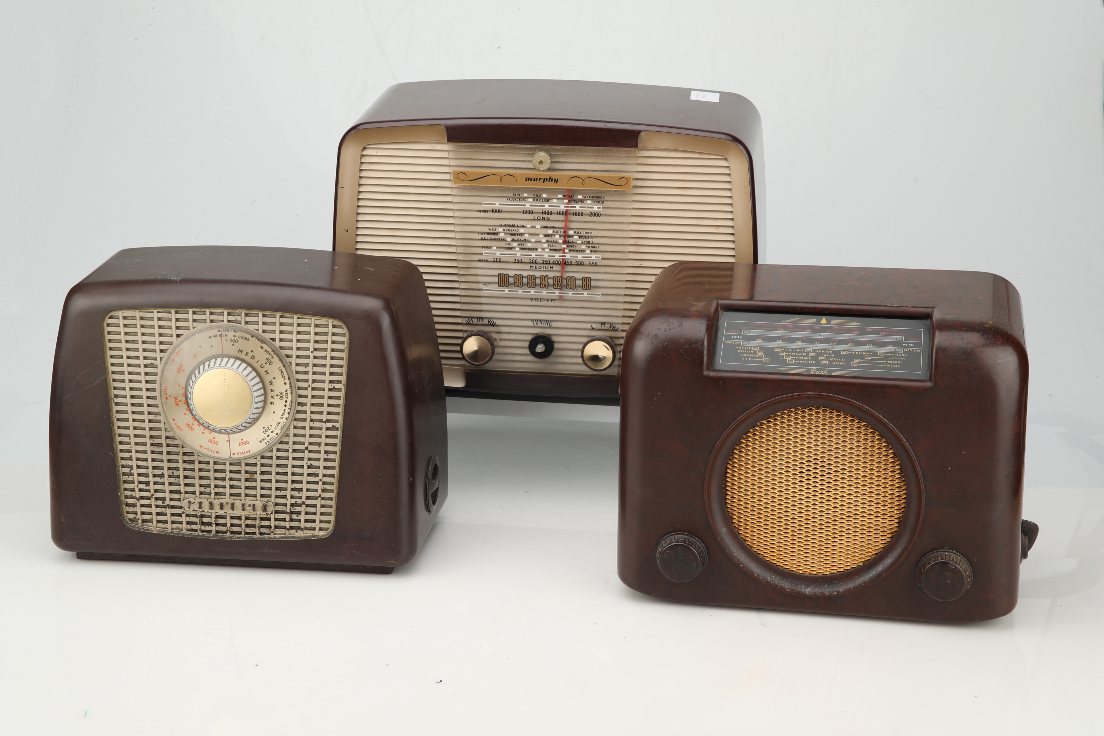 1950 Bush Type PB22 valve radio with Bakelite knobs and central glass  tapering panel between with gilt metal mesh speakers, W58cm H42cm D24cm,  together with Cossor floor standing radio in walnut venee 