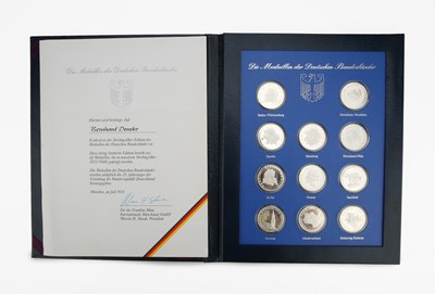 Lot 42 - A cased set of 11 silver medallions celebration figures from the German Republic