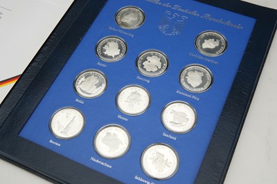 Lot 42 - A cased set of 11 silver medallions celebration figures from the German Republic