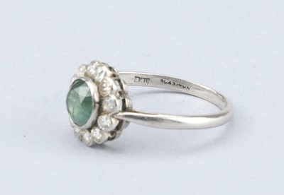 Lot 140 - An Art Deco Diamond and Emerald Platinum Cluster Ring