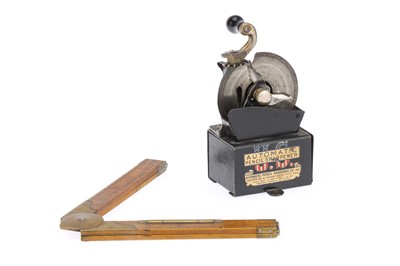 Lot 769 - A Pencil Sharpener and a Rule