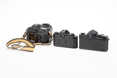 Lot 31 - Three Nikon SLR Cameras
