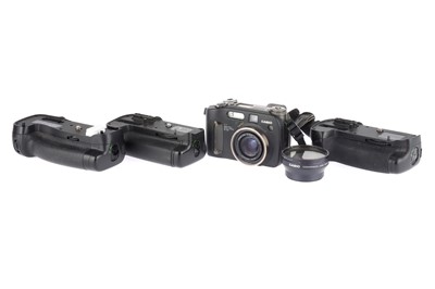 Lot 964 - Three Battery Grips & a Casio Camera