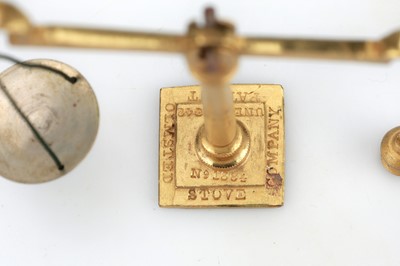 Lot 373 - A gilt brass Olmsted Patent Stove Company Pocket Sovereign Scale