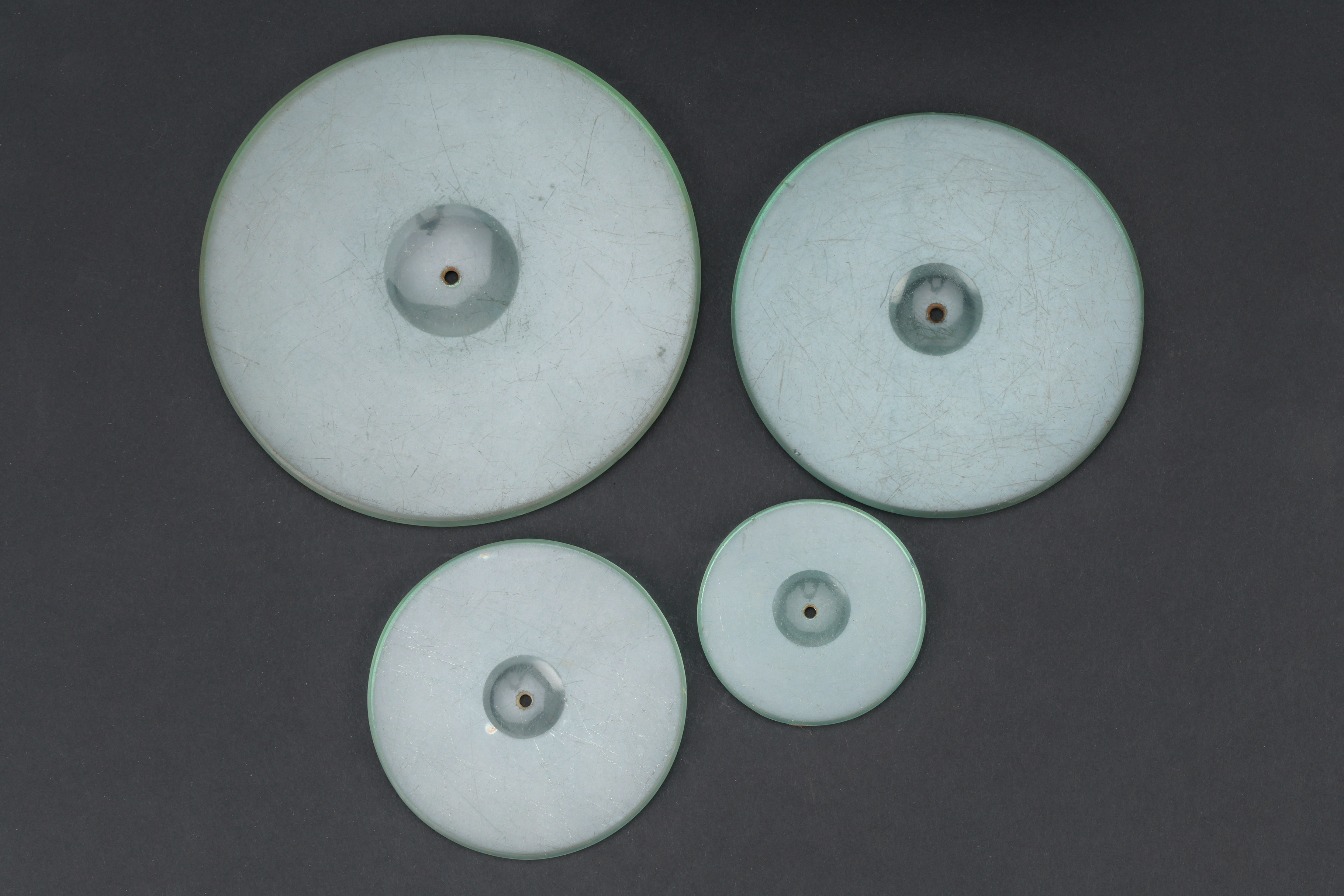 Lot 705 - A part-set of four circular glass strikes