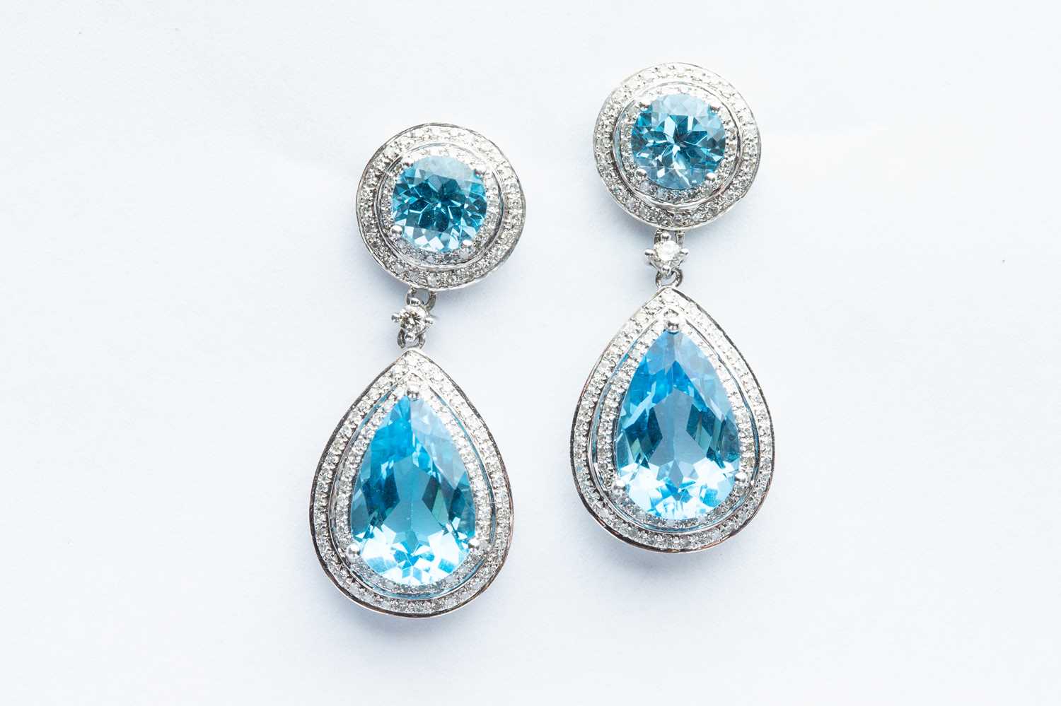 Lot 21 - A Pair of 14ct White Gold Blue Topaz & Diamond Drop Earrings