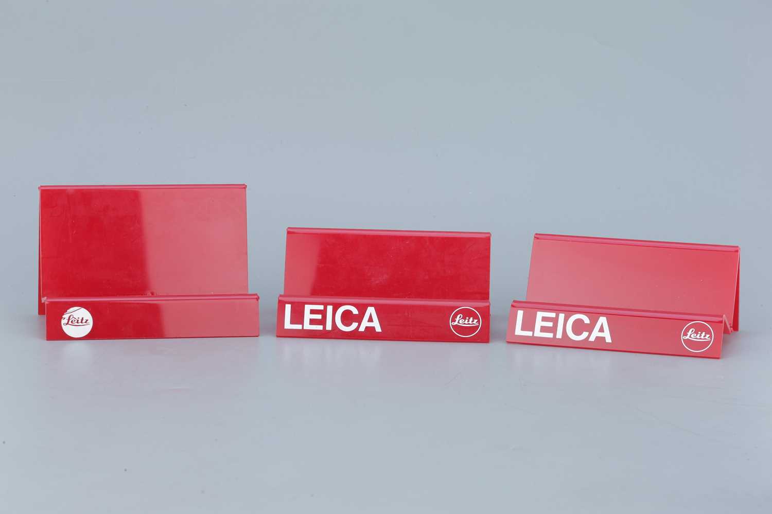 Lot 201 - Three Red Acrylic Leica Display Stands